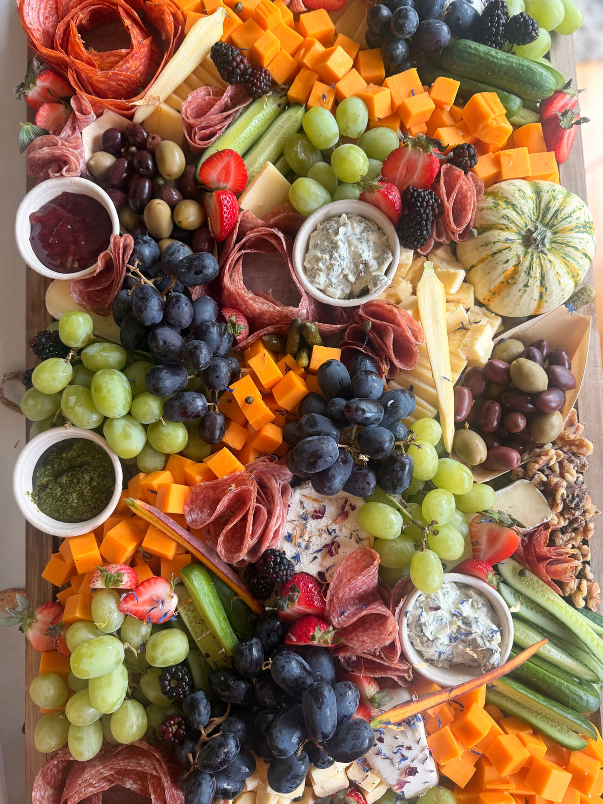 The Capitol Hill Classic Ultimate Grazing Board by District Boards: salami roses, cheddar cubes, grapes, berries, cucumbers and dips