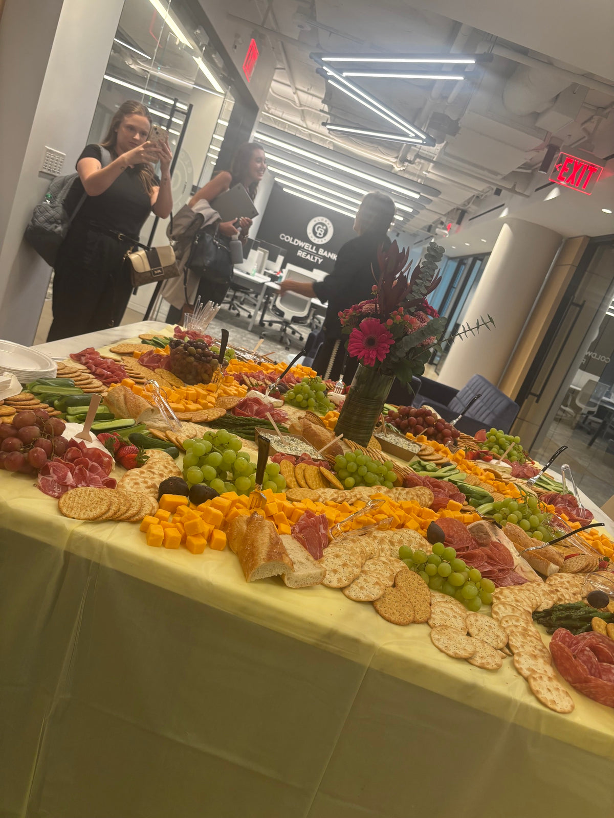 Guests at a corporate event with a District Boards grazing table