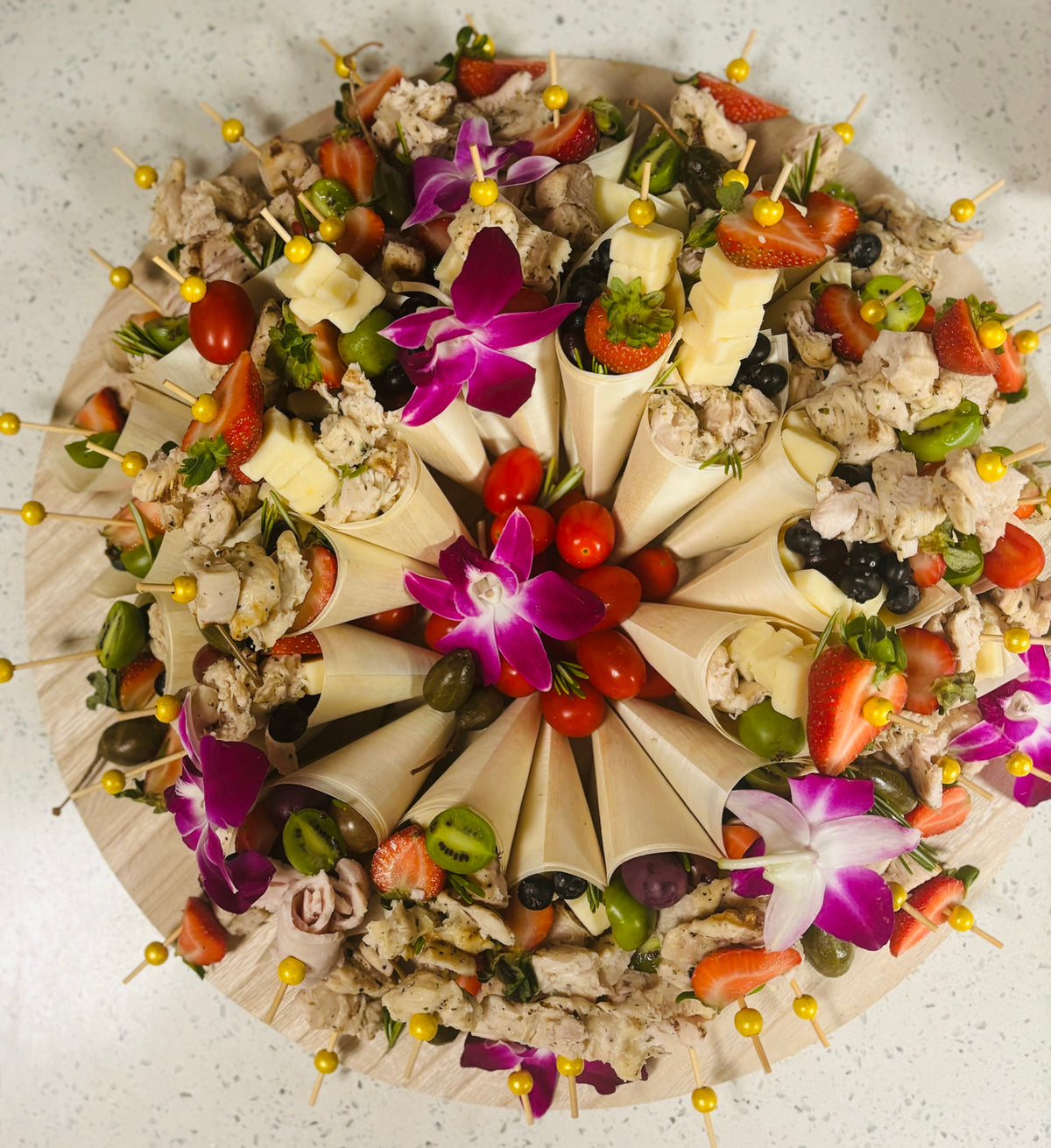 Executive charcuterie cones arranged on a platter with orchids