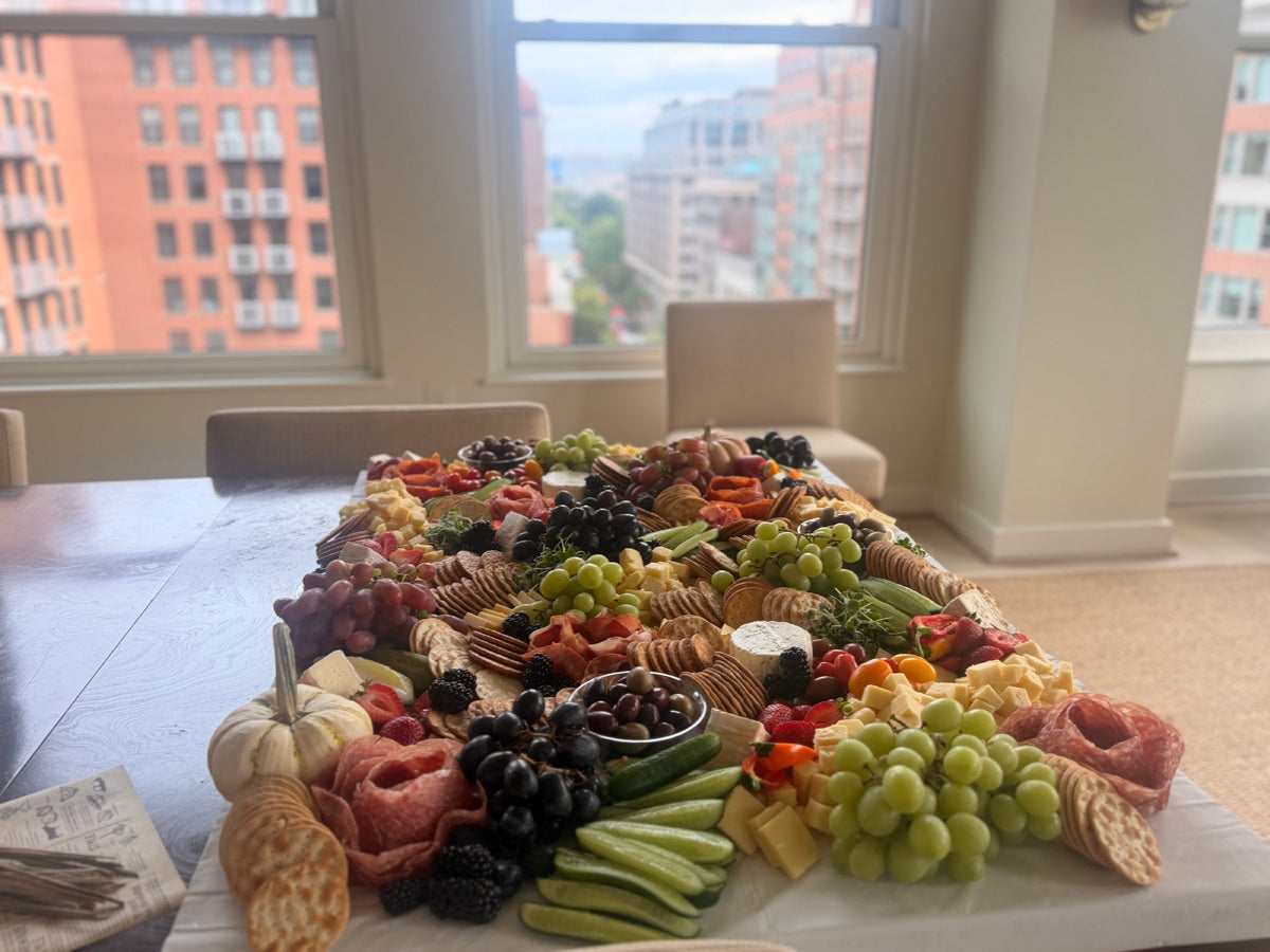 Federal Reserve Graze grazing table set up in a Washington, DC apartment with a city view